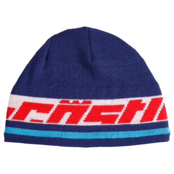 The Live Pom Beanie is a blue knit beanie featuring a stylish white and red stripe near the bottom. The red section showcases an abstract pattern or text, and there's also a thin turquoise stripe just below the red and white stripe.